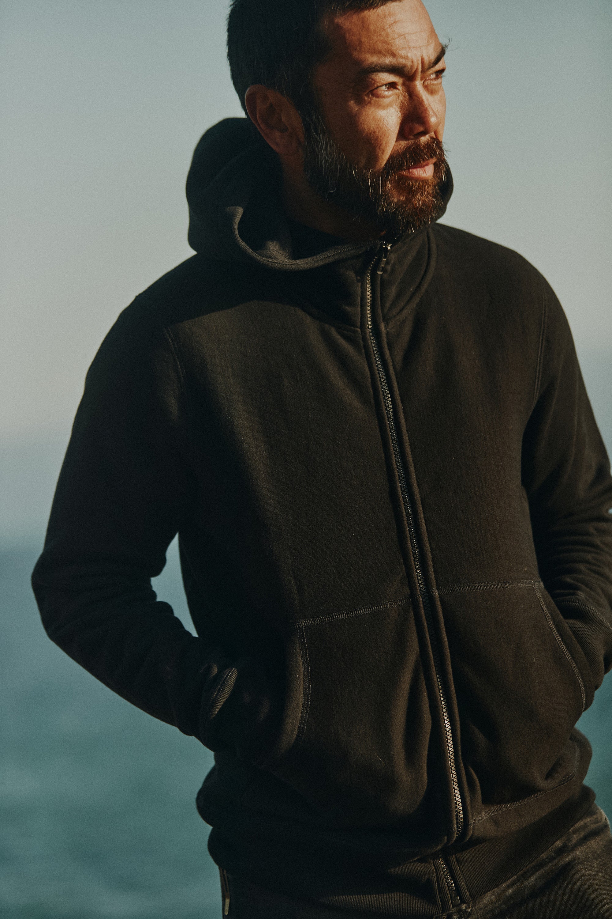 Close up shot of a man wearing Foreign Rider High Neck Hooded Sweatshirt