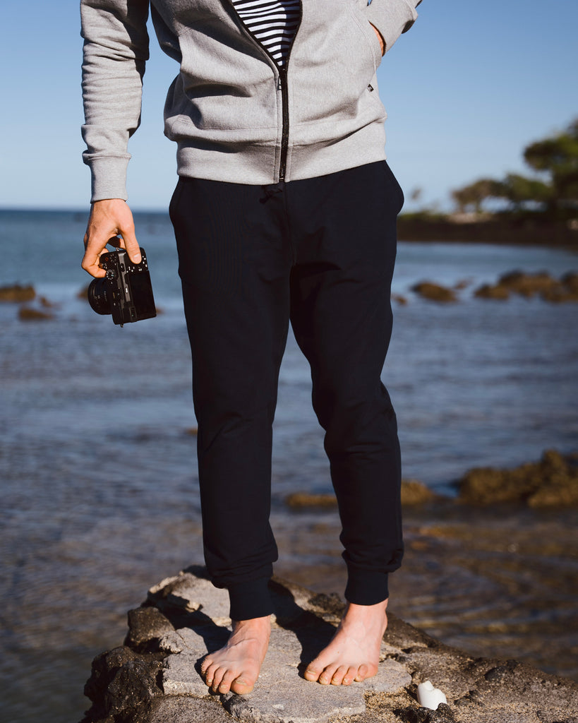 Eric Lagerstrom wearing Foreign Rider Co Performance Jogger standing on a rock on a hawaii shoreline