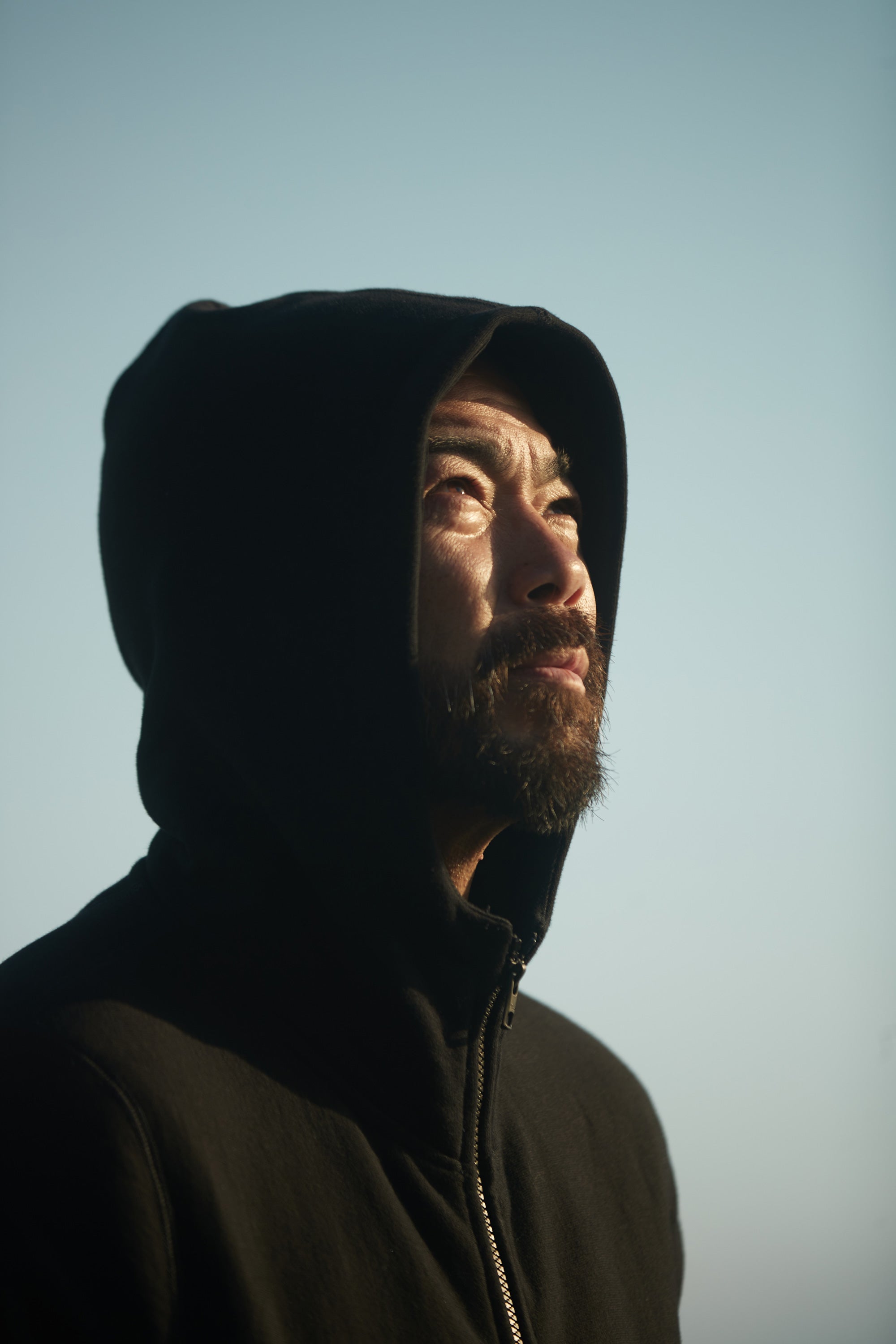 Close up shot of a man with the hood up of the Foreign Rider High Neck Hooded Sweatshirt