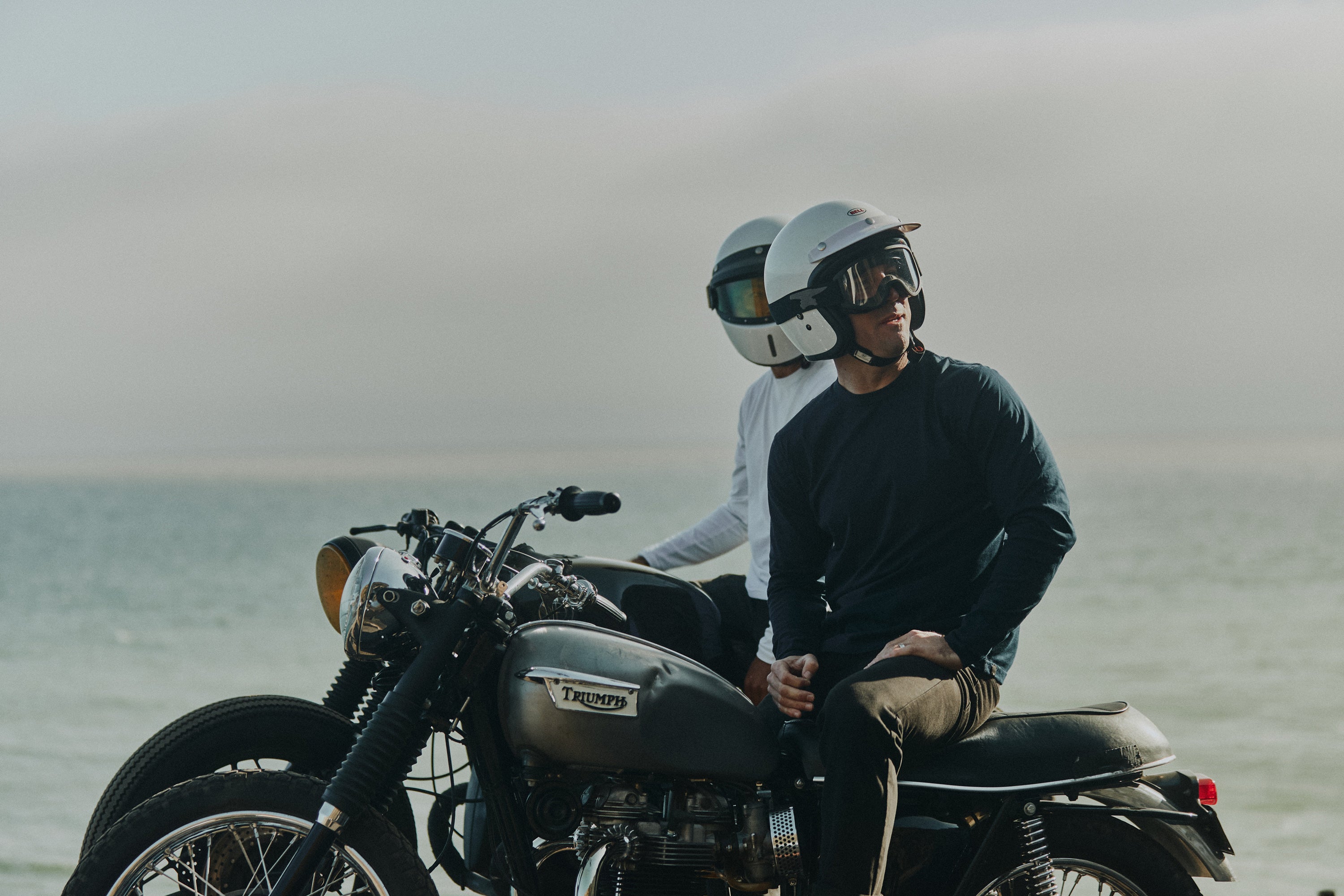 2 men sitting on vintage motorbikes with the Pacific ocean in the background wearing Foreign Rider Supima Long Sleeve T-shirt