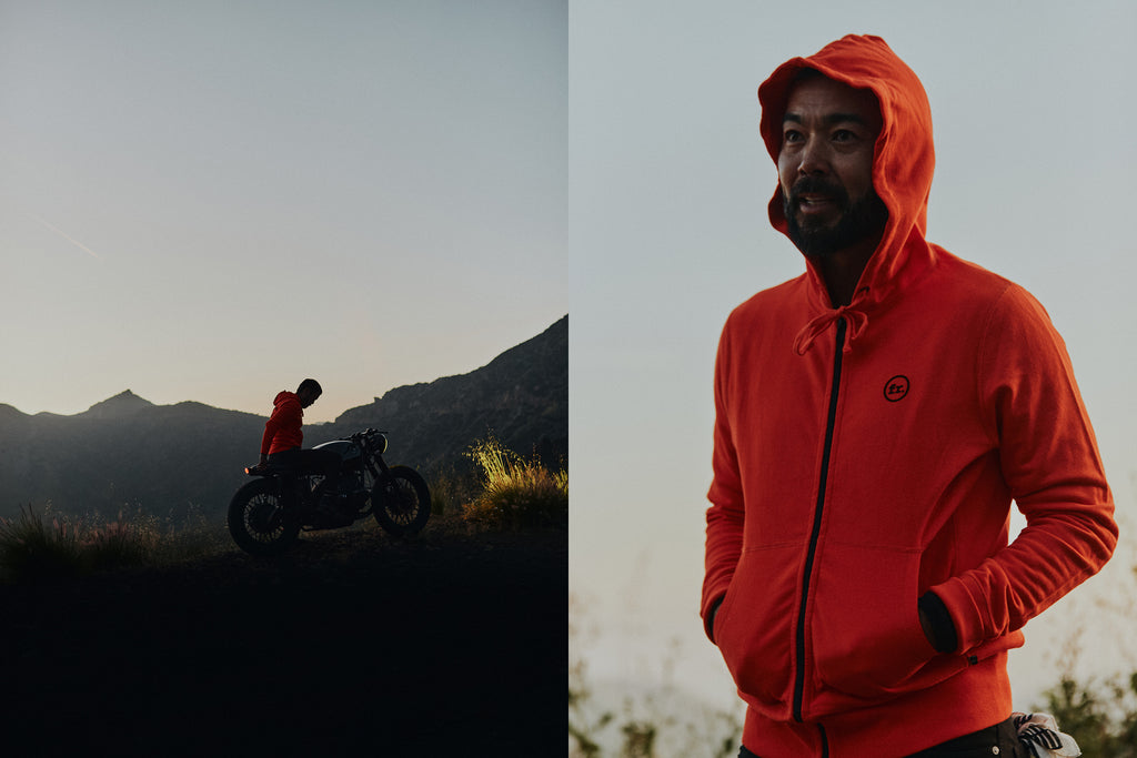 Split image of a man on the left sitting on a vintage motorbike at sunset & the right man wearing the Foreign Rider Full Zip Hooded Vintage Sweatshirt