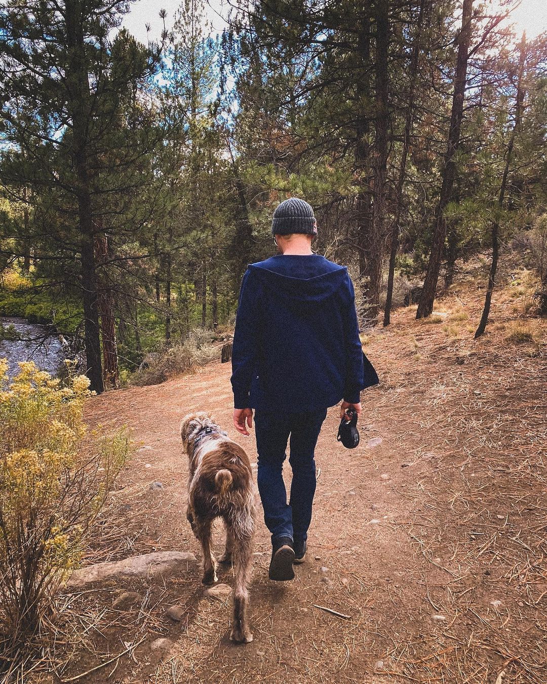 Eric Lagerstrom walking alongside his dog Flynn