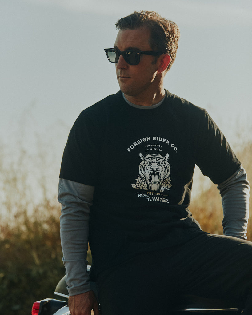 Man sitting on motorbike wearing Foreign Rider Graphic Tiger T-shirt