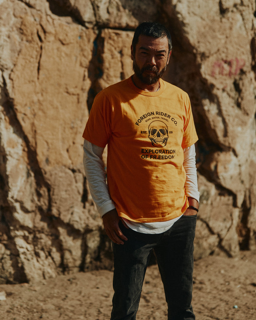 Man standing in front of Santa Monica mountains wearing Foreign Rider Skull T-shirt