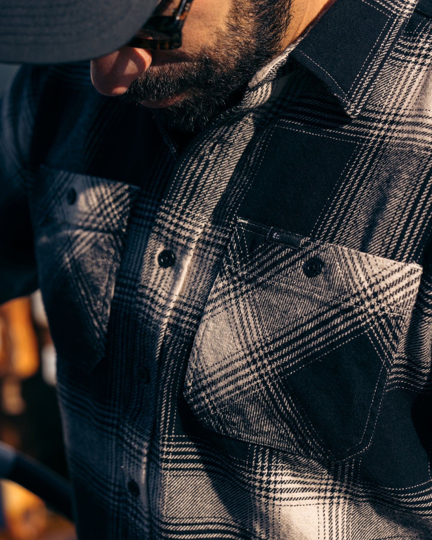 Close up on the chest pockets and buttons of Foreign Rider Co Black Flannel
