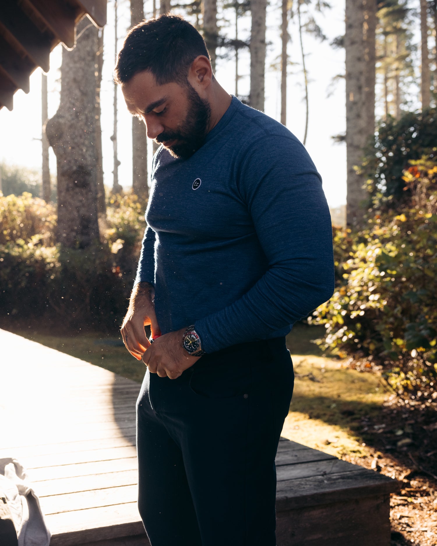 Side view of man tying up drawstring and wearing Foreign Rider Co Merino Long Sleeve T-shirt