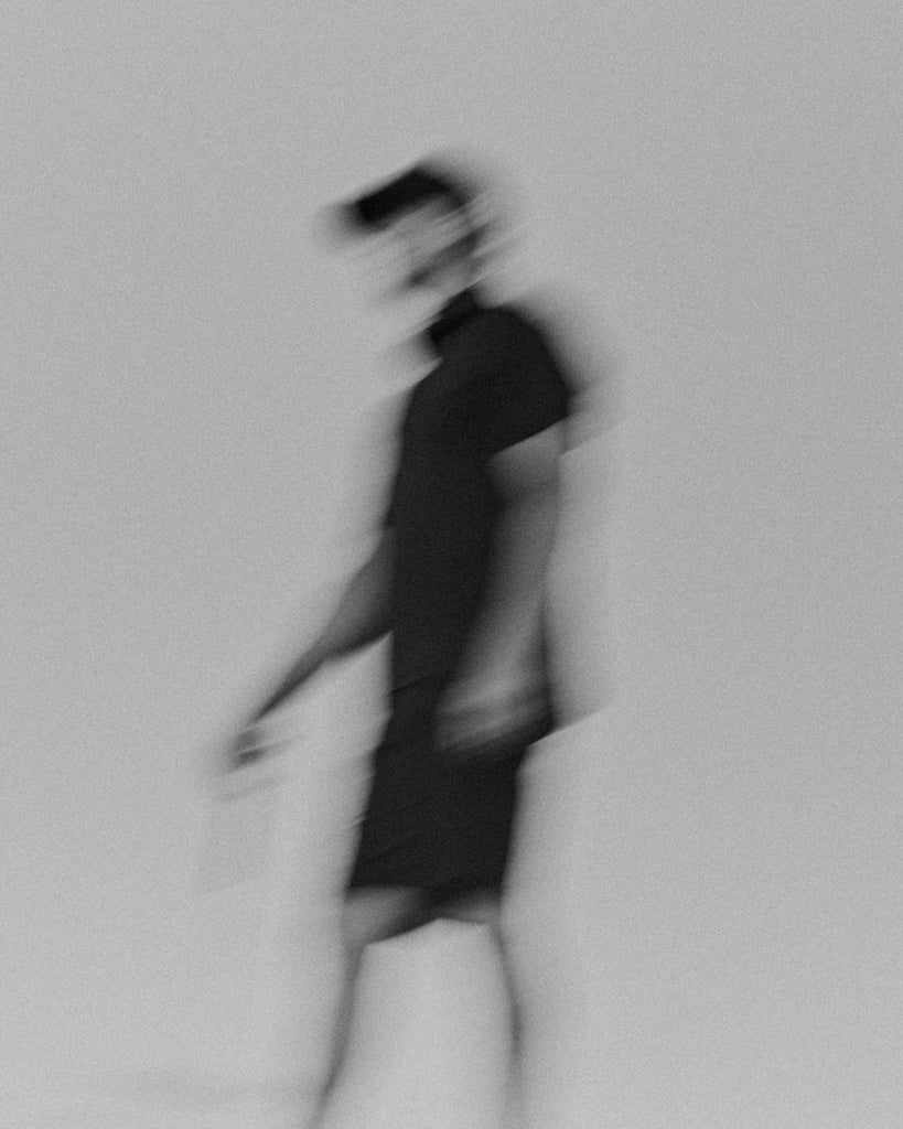 Black and white abstract blurry image of golfer walking at the Grove XXIII Golf Club