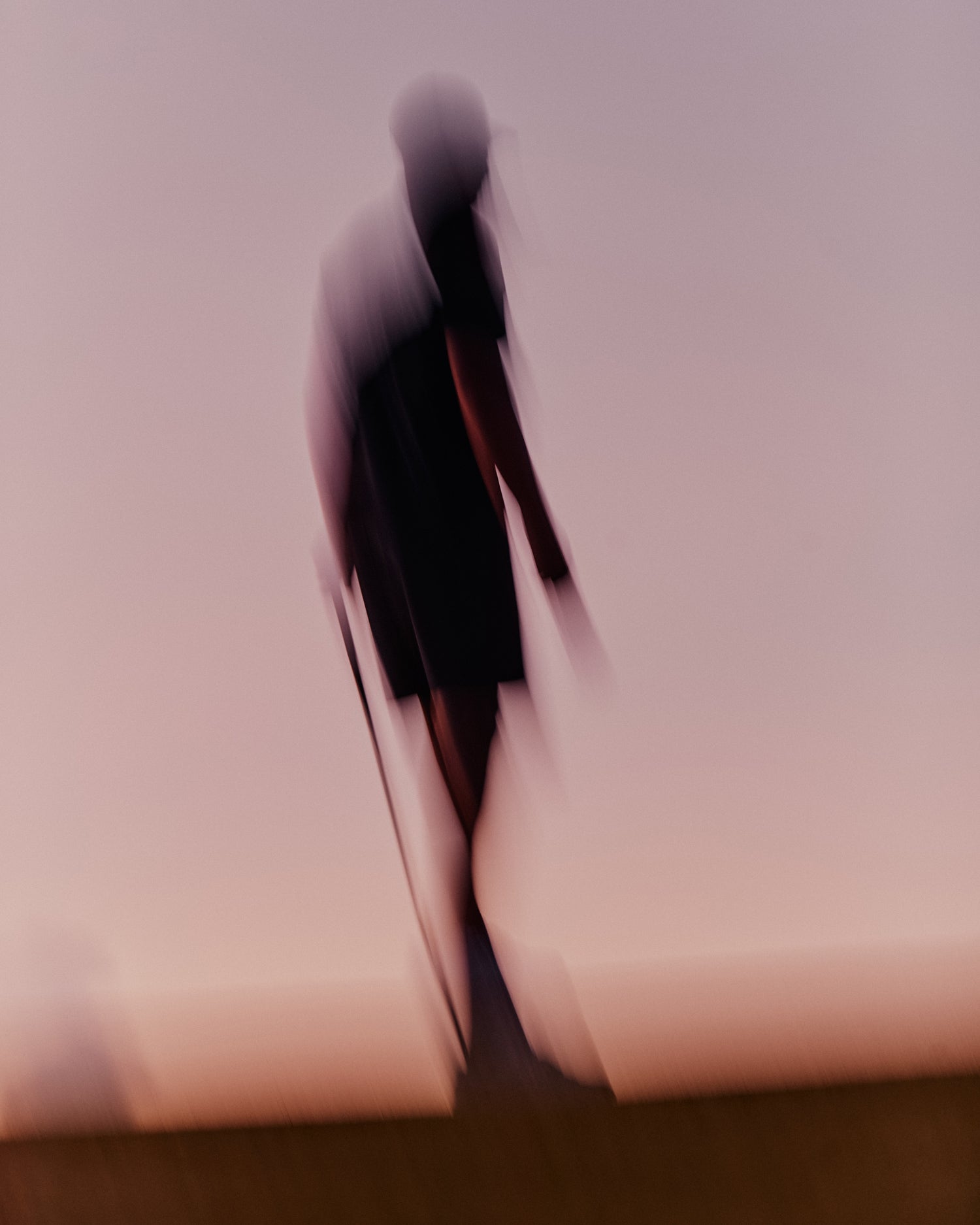 Abstract blurry golfer standing at the Grove XXIII Golf Club with a red pink skyline