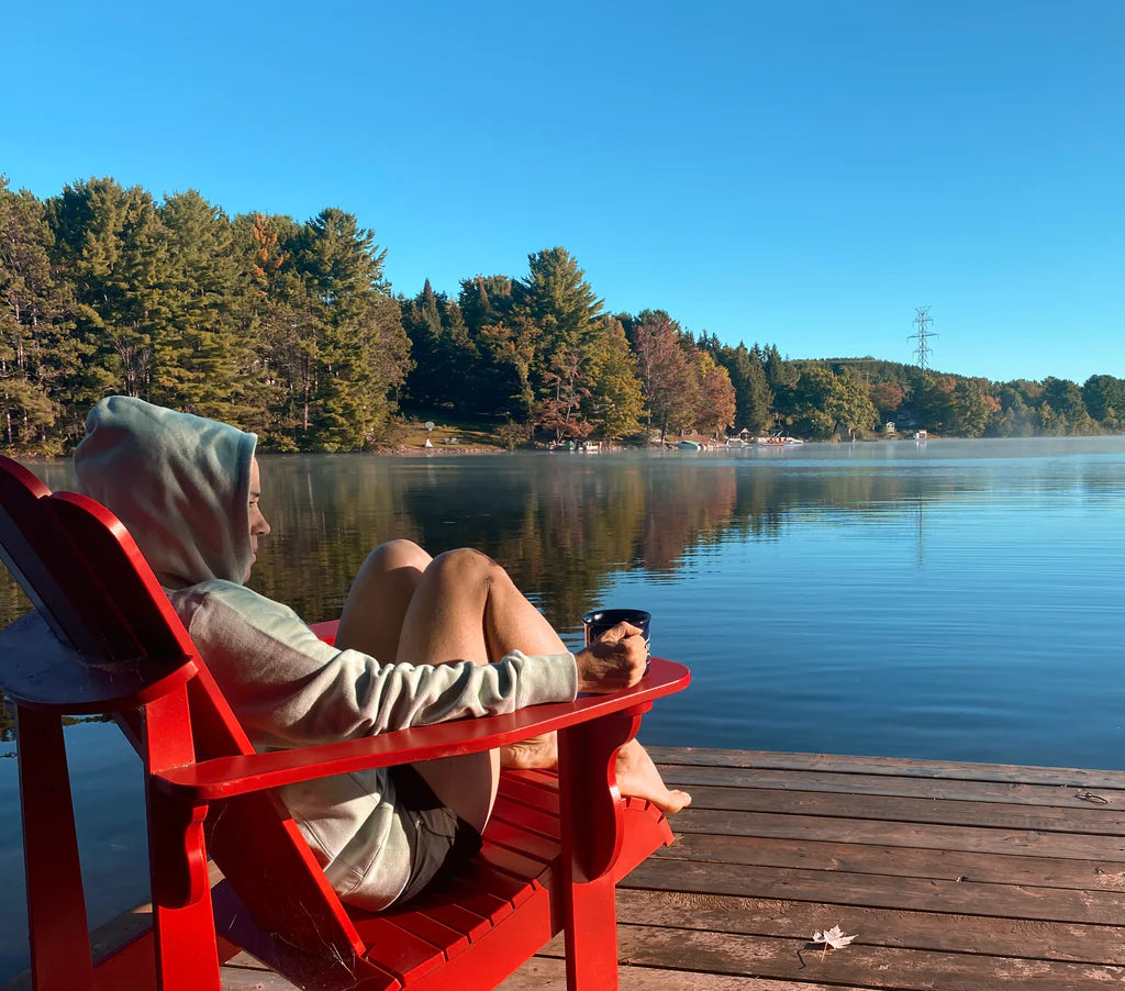 Shannon Kemp sitting in a Adirondack chair on a dock of a lake