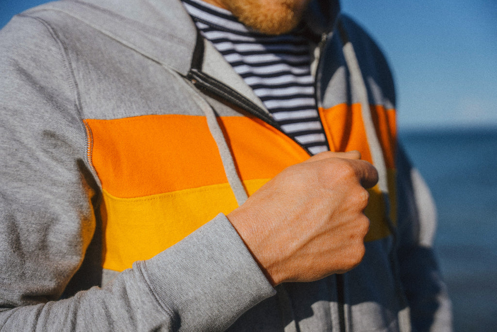 Close up detail of Eric Lagerstrom zipping up a Foreign Rider Sweatshirt