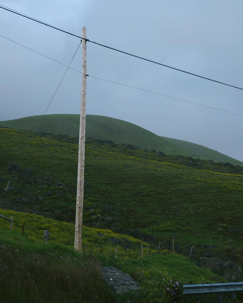 Hawaii Island green mountain and hill in the background and a telephone poll in the foreground