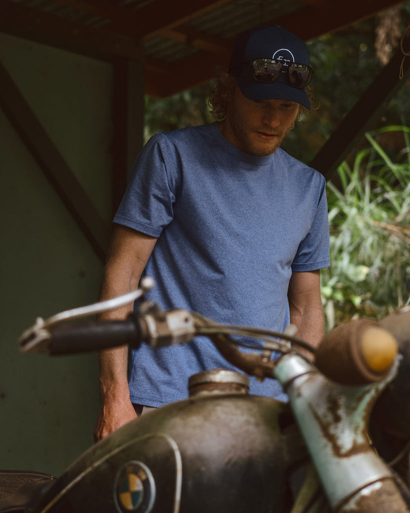 Eric Lagerstrom looking at vintage rusty BMW motorcycle